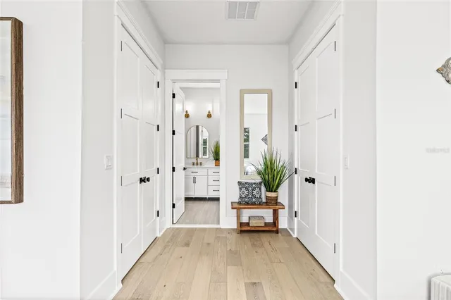 a bathroom with a double vanity sink a toilet and a window