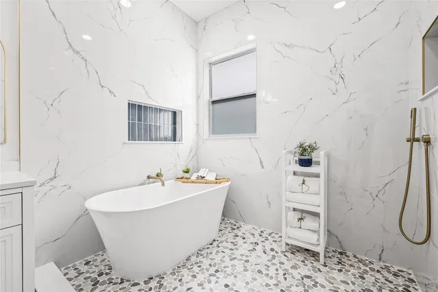 a bathroom with a granite countertop toilet sink and mirror