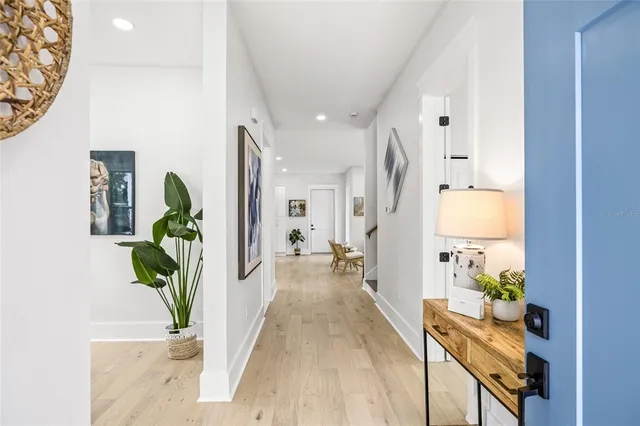 a view of a hallway with wooden floor