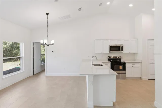 a kitchen with white cabinets and white appliances