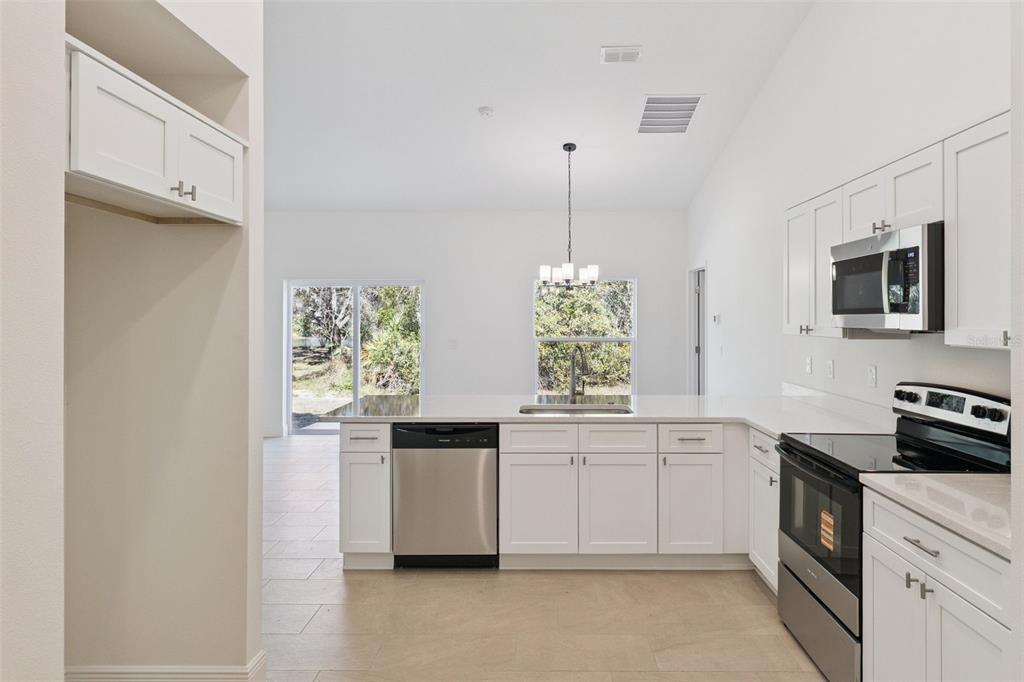 121 South Canoe Creek Road Kenansville, FL 34739 - Photo 12 of 54 a kitchen with cabinets and window