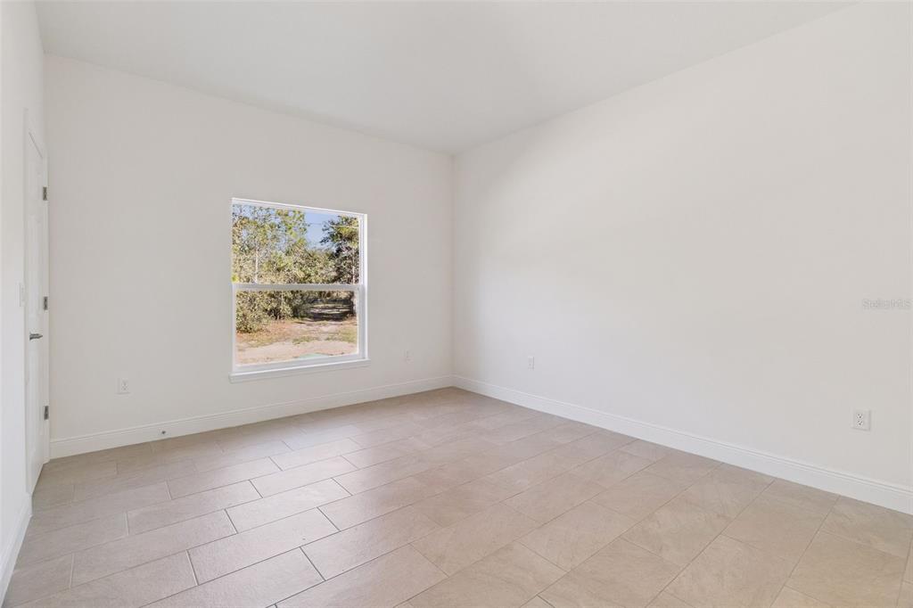 121 South Canoe Creek Road Kenansville, FL 34739 - Photo 20 of 54 an empty room with a window