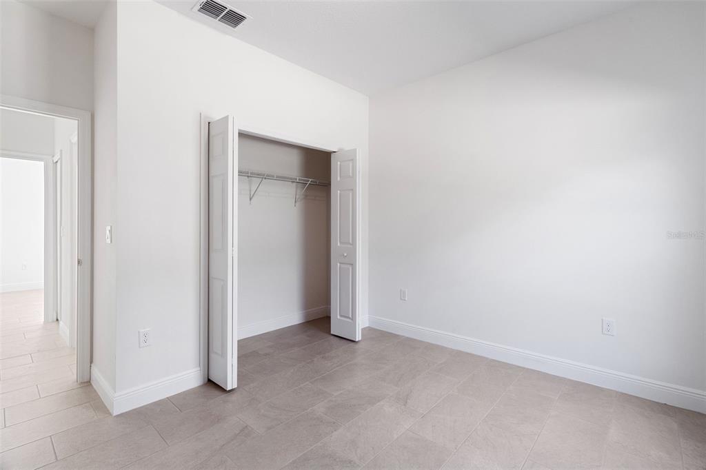 121 South Canoe Creek Road Kenansville, FL 34739 - Photo 21 of 54 an empty room with closet