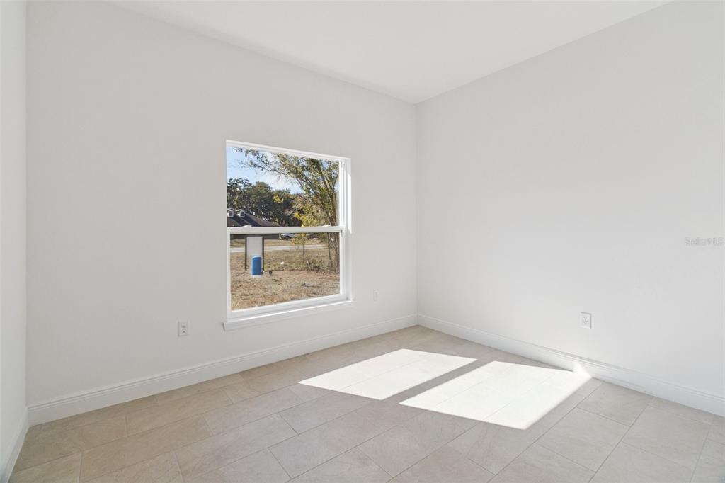 121 South Canoe Creek Road Kenansville, FL 34739 - Photo 22 of 54 an empty room with a window