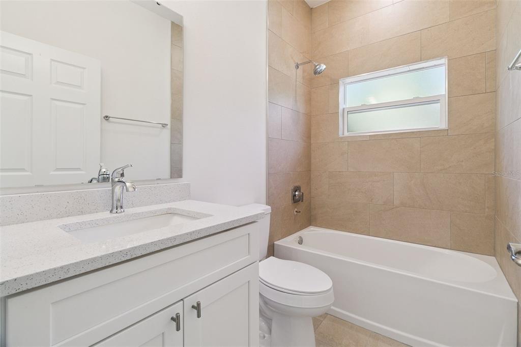 121 South Canoe Creek Road Kenansville, FL 34739 - Photo 27 of 54 a bathroom with a sink a toilet and shower
