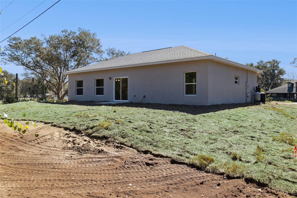 121 South Canoe Creek Road Kenansville, FL 34739 - Photo 36 of 54 a house with a yard