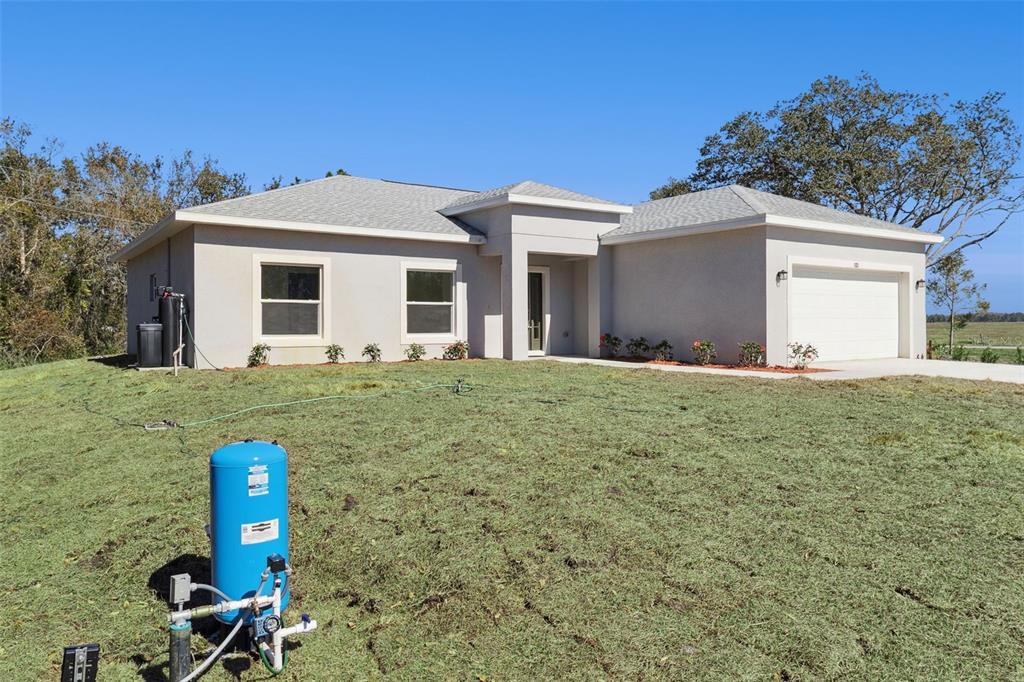 121 South Canoe Creek Road Kenansville, FL 34739 - Photo 37 of 54 a front view of a house with a yard