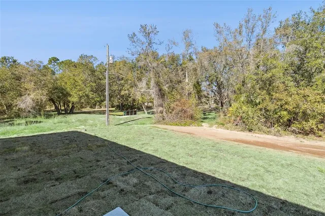an aerial view of a house with yard swimming pool and outdoor seating