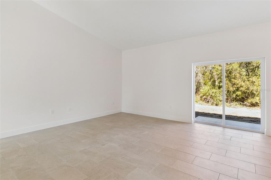 121 South Canoe Creek Road Kenansville, FL 34739 - Photo 4 of 54 an empty room with windows