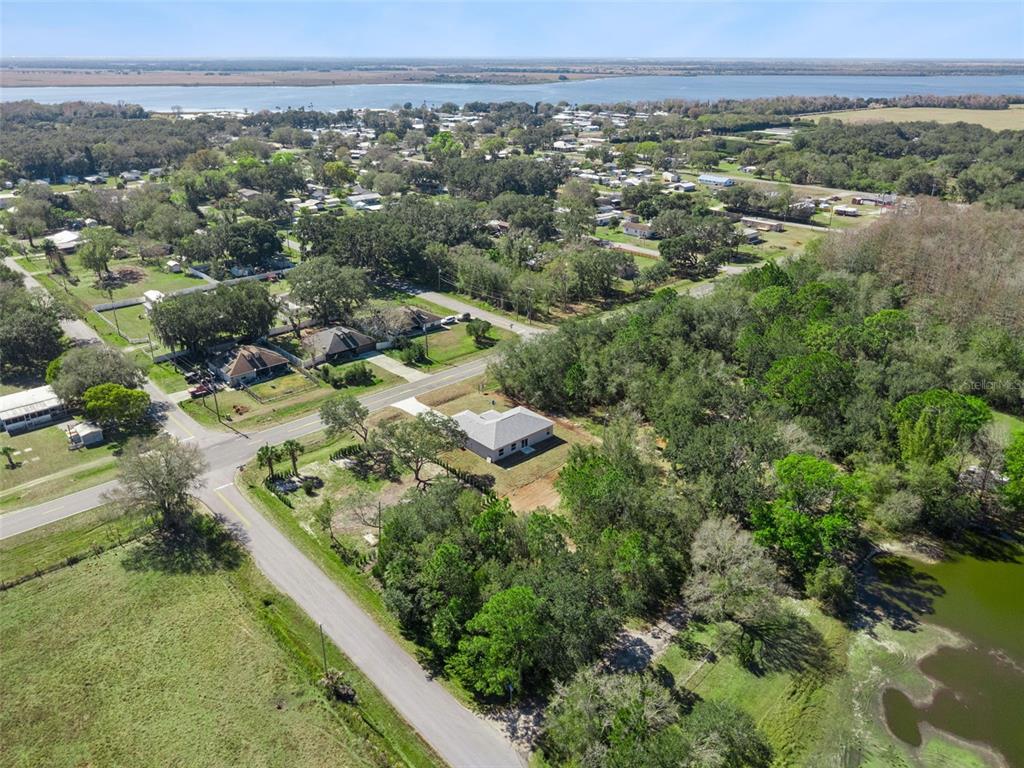 121 South Canoe Creek Road Kenansville, FL 34739 - Photo 50 of 54 an aerial view of green landscape with trees houses and mountain view