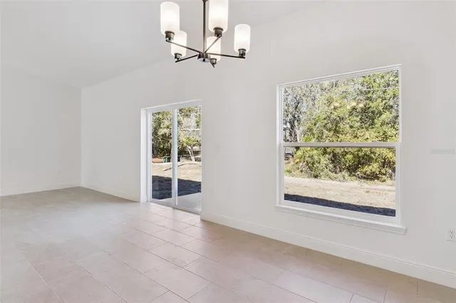 a view of a kitchen with a sink and chandelier