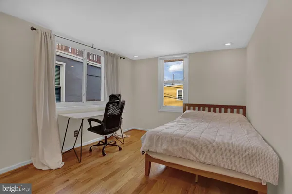 a bedroom with a bed and a desk