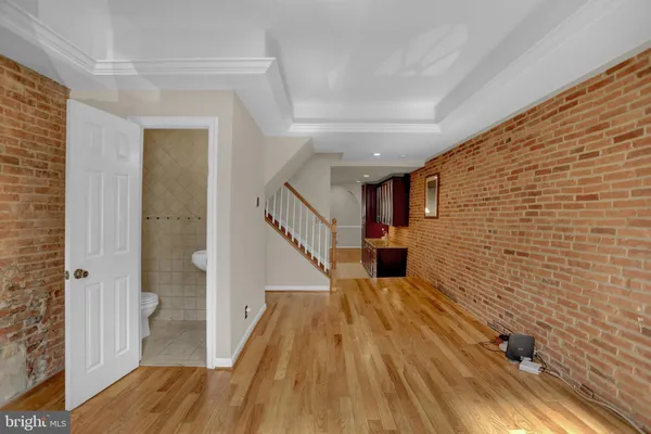 a view of a hallway with wooden floor and staircase