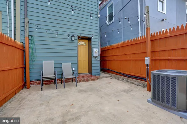 a backyard of a house with table and chairs