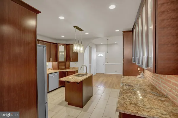 a view of a hallway with a couch and chandelier