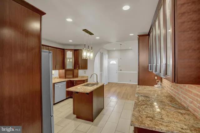 a view of a hallway with a couch and chandelier