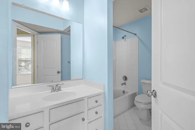 a bathroom with a granite countertop sink toilet a large mirror and shower