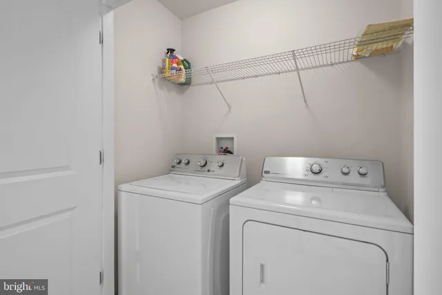 a view of storage and utility room with washer and dryer