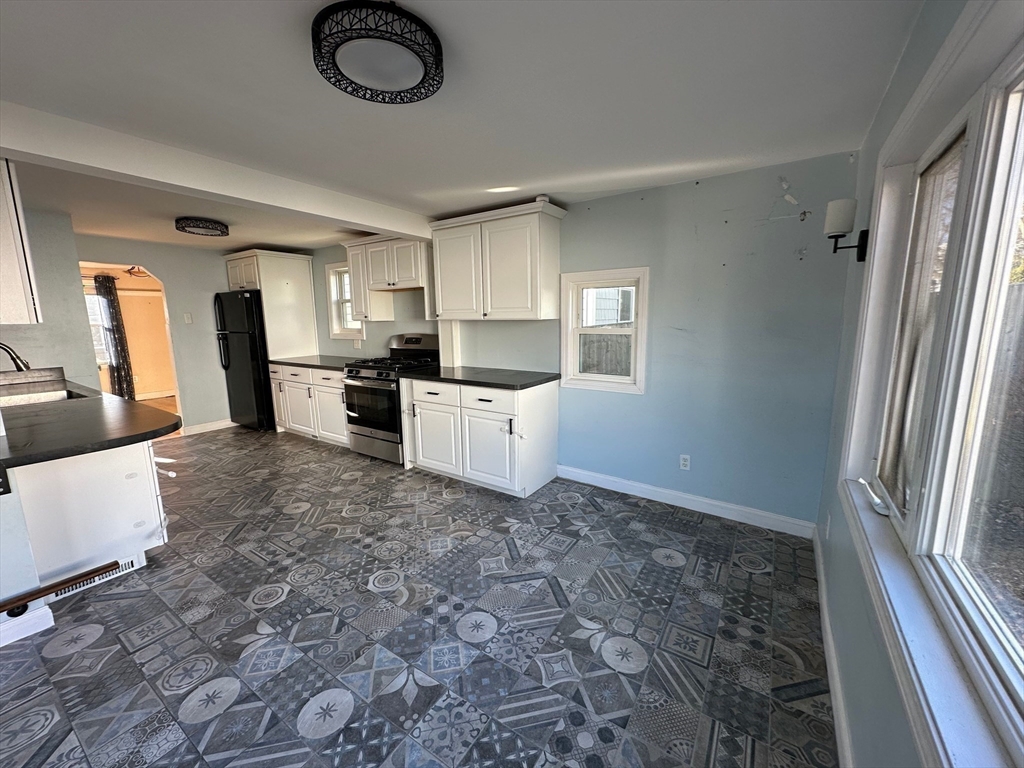 156 Parke Avenue Quincy, MA 02171 - Photo 15 of 23 a kitchen with stainless steel appliances a refrigerator a sink a stove top oven and cabinets