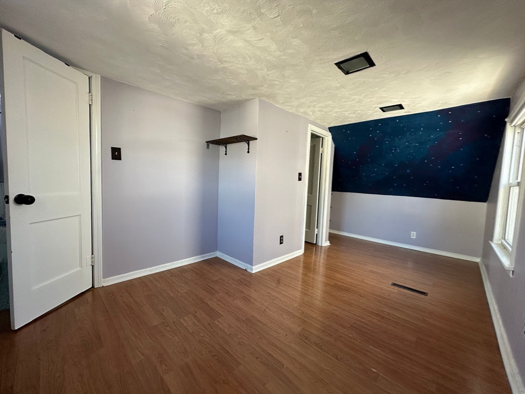 156 Parke Avenue Quincy, MA 02171 - Photo 18 of 23 a view of an empty room with wooden floor and a bathroom
