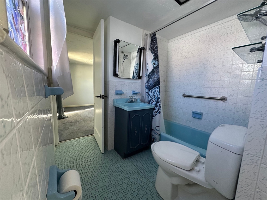 156 Parke Avenue Quincy, MA 02171 - Photo 21 of 23 a bathroom with a toilet sink and mirror