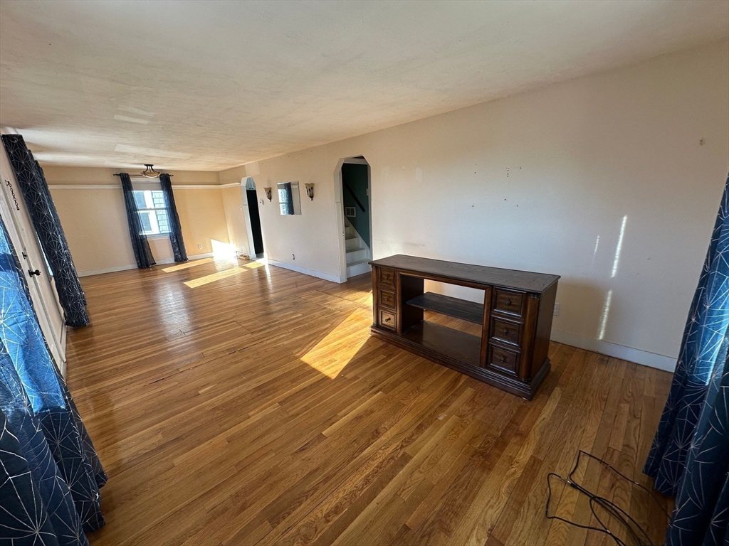 156 Parke Avenue Quincy, MA 02171 - Photo 10 of 23 a view of empty room with wooden floor and fan