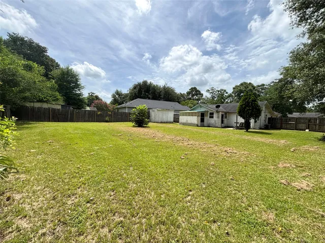 a view of a swimming pool with a yard