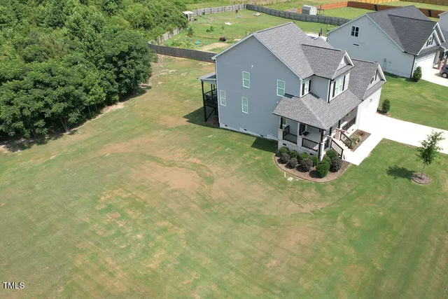a aerial view of a house with table and chairs