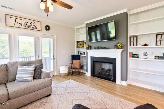 a kitchen with stainless steel appliances kitchen island granite countertop a table chairs and a refrigerator
