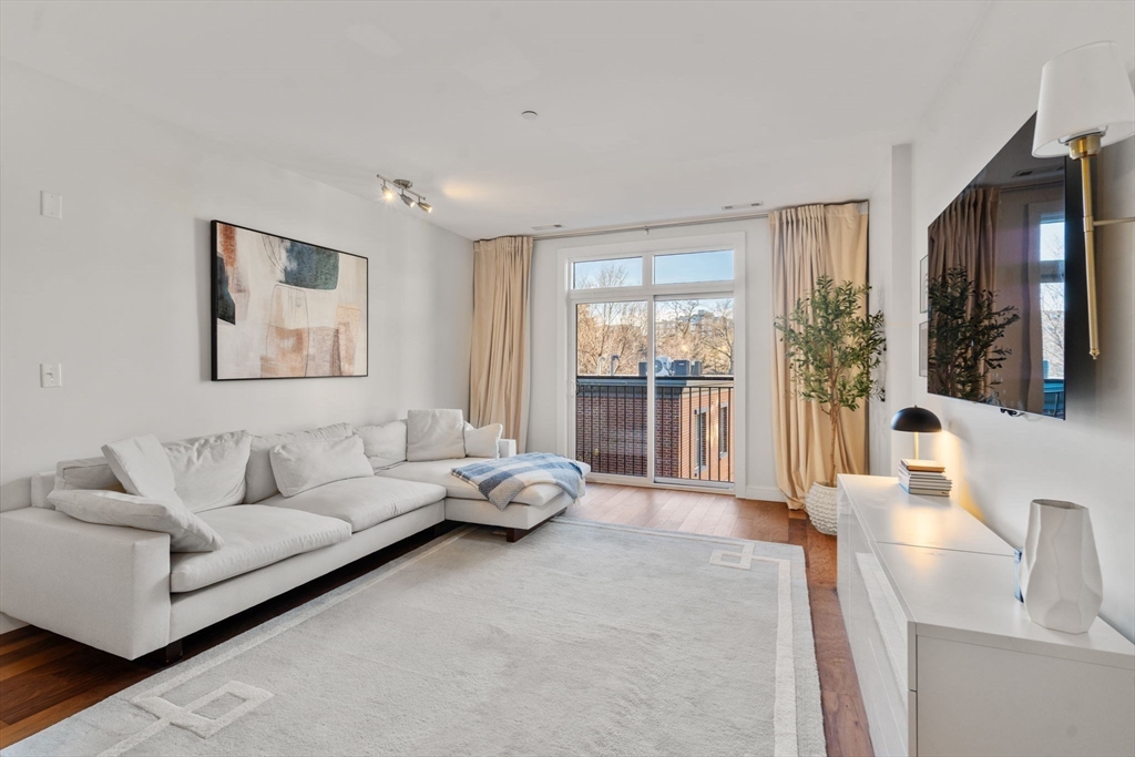 1501 Commonwealth Avenue, Unit 409 Boston, MA 02135 - Photo 5 of 17 a living room with furniture and a large window