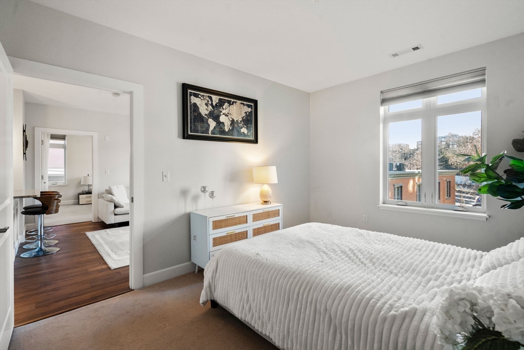 1501 Commonwealth Avenue, Unit 409 Boston, MA 02135 - Photo 6 of 17 a bedroom with a bed and a large window