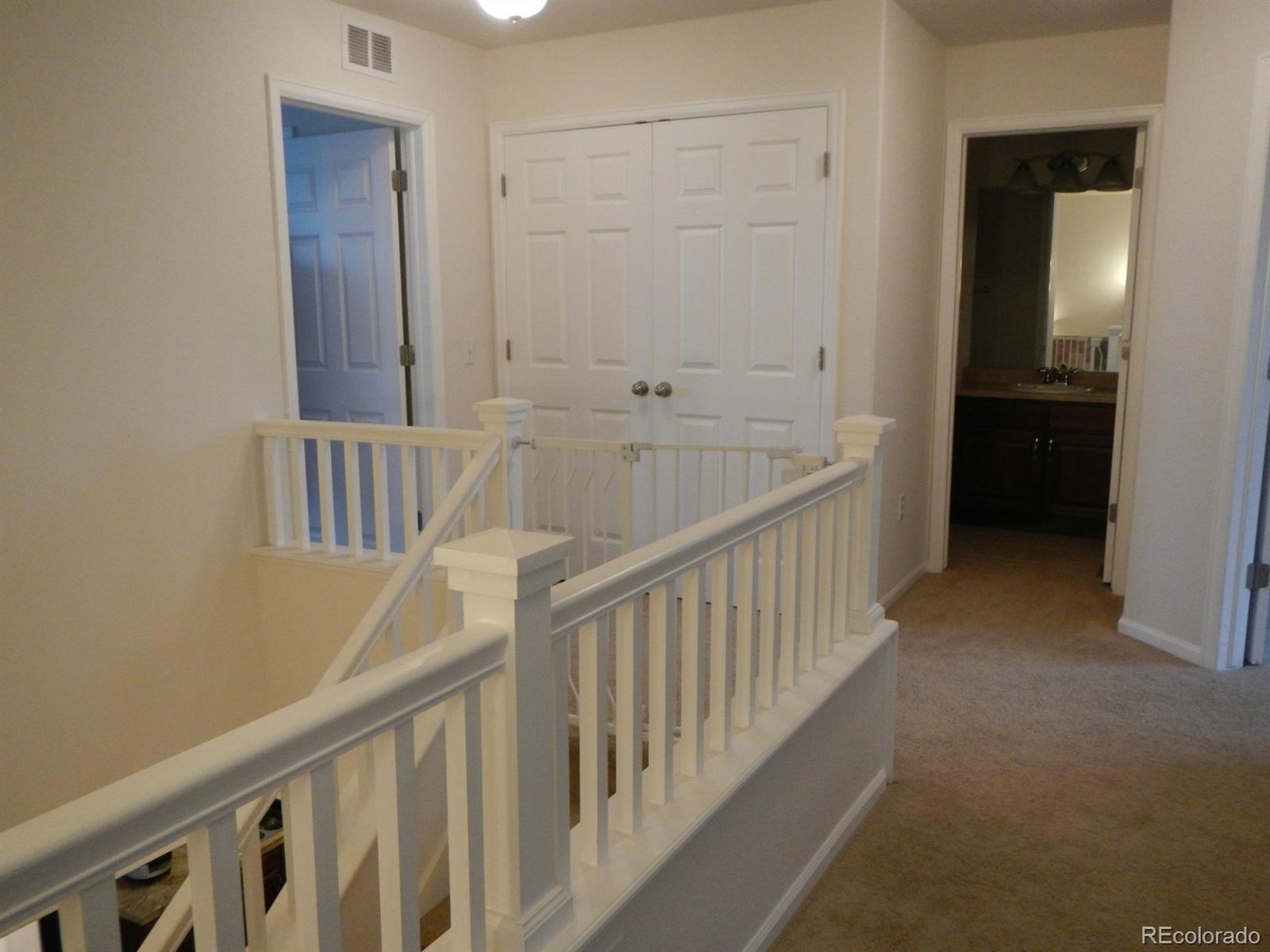 3652 South Perth Circle, Unit 102 Aurora, CO 80013 - Photo 11 of 17 a view of staircase with railing and white walls