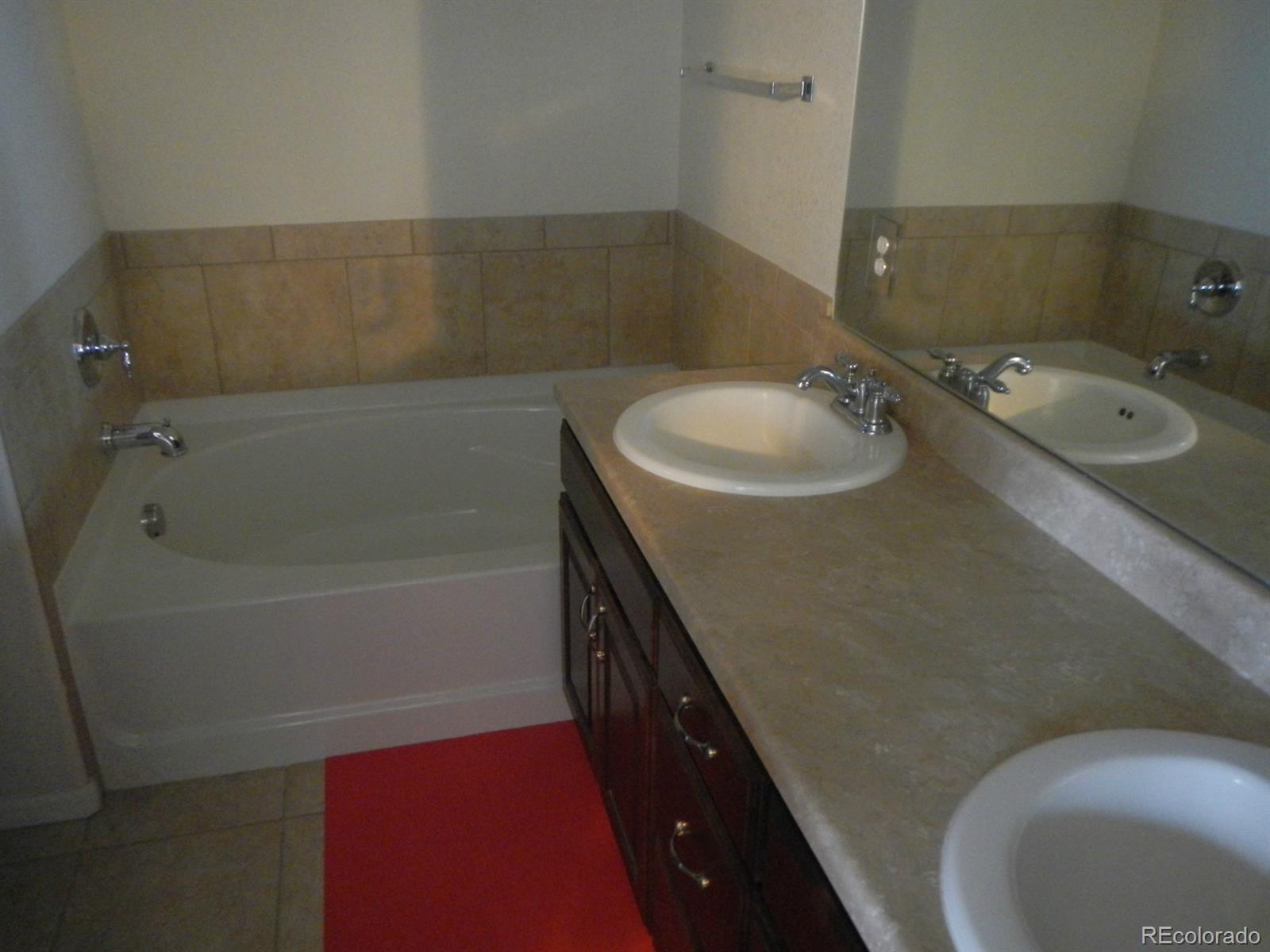 3652 South Perth Circle, Unit 102 Aurora, CO 80013 - Photo 12 of 17 a bathroom with a sink and a mirror