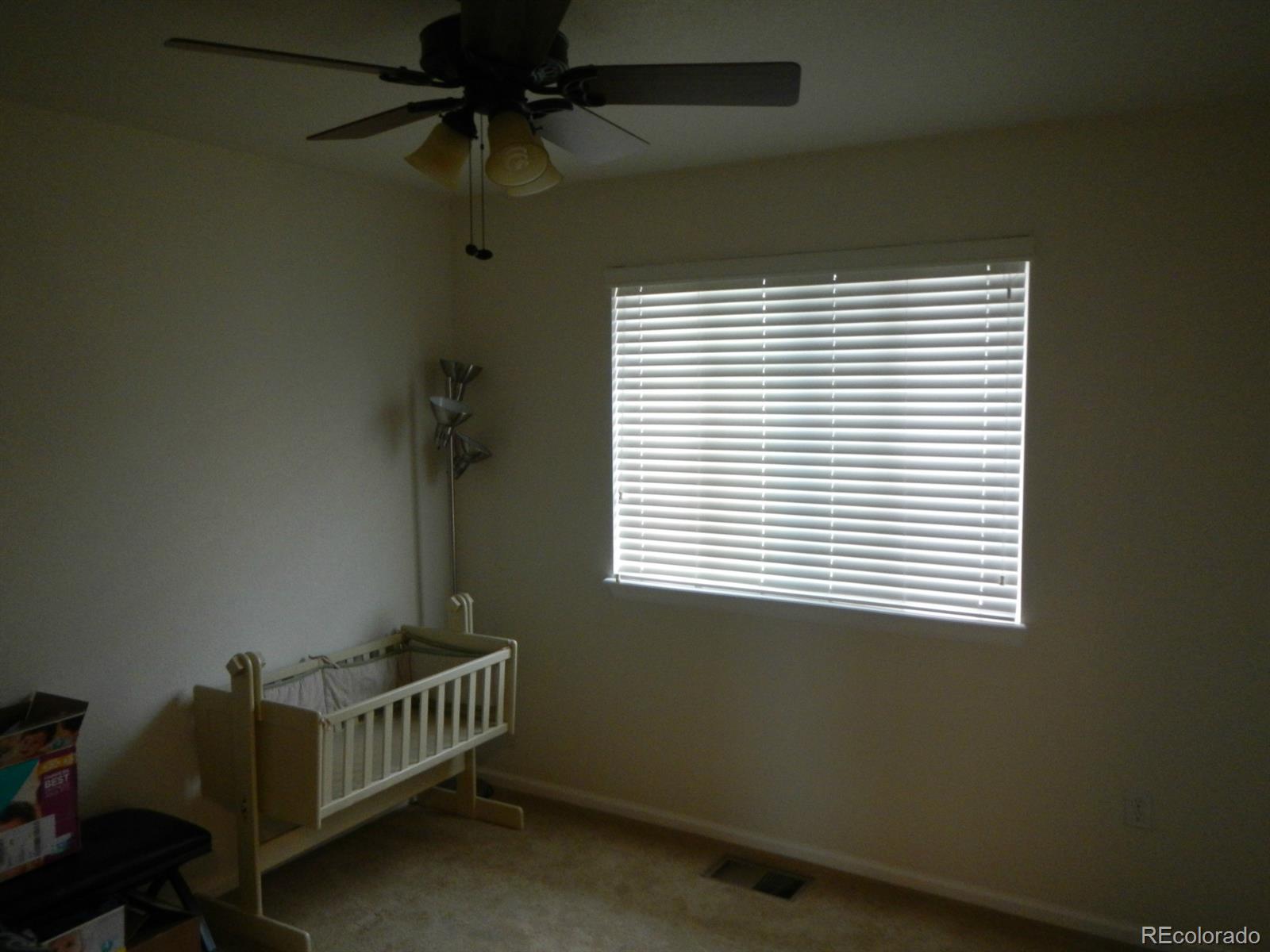 3652 South Perth Circle, Unit 102 Aurora, CO 80013 - Photo 13 of 17 a bedroom with a window and a fan