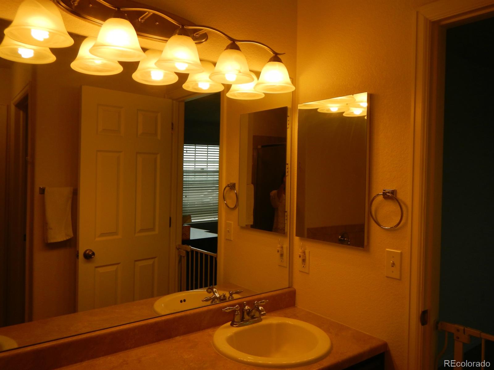 3652 South Perth Circle, Unit 102 Aurora, CO 80013 - Photo 15 of 17 a bathroom with a sink mirror and vanity