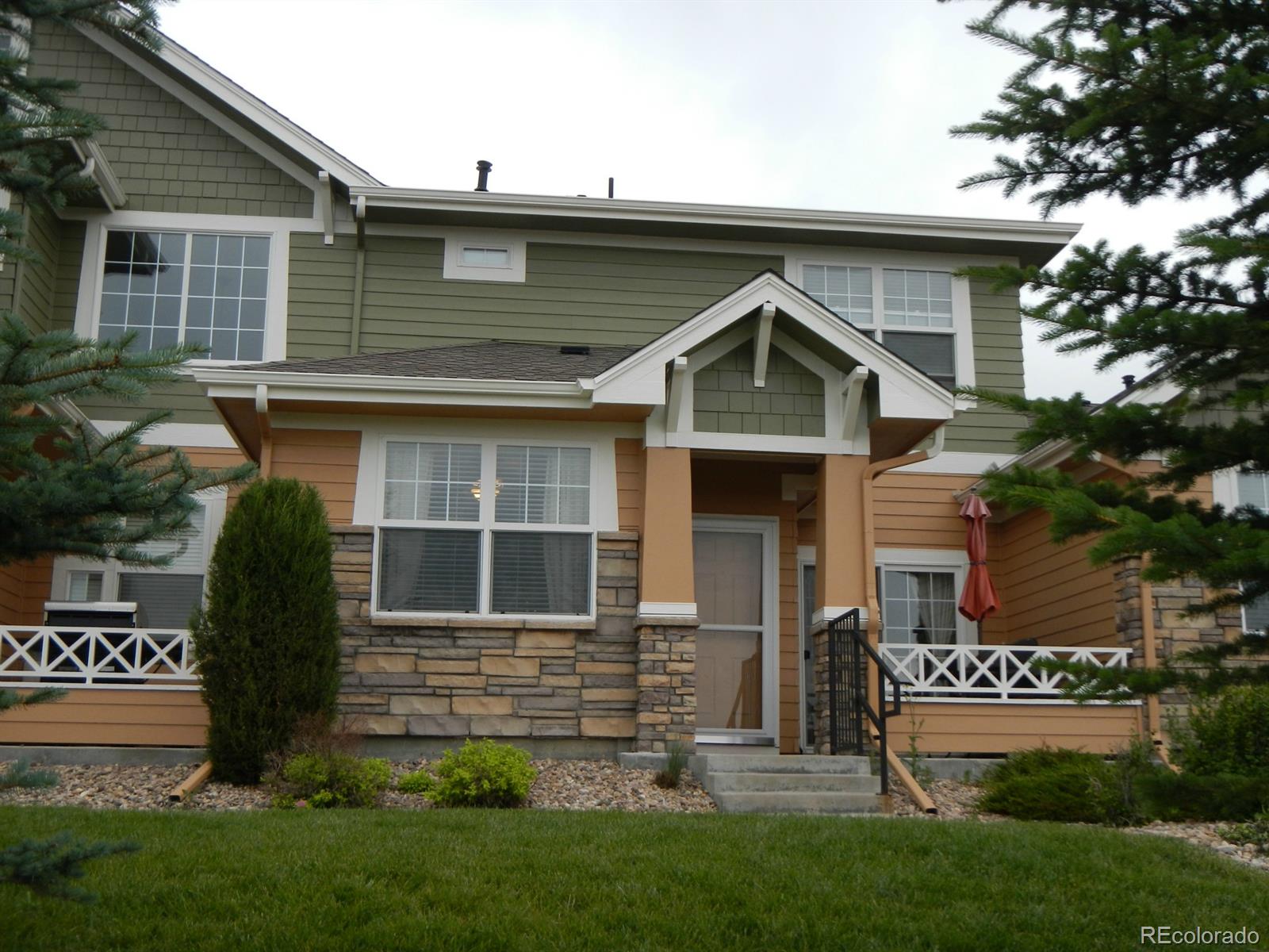 3652 South Perth Circle, Unit 102 Aurora, CO 80013 - Photo 2 of 17 a front view of a house with a garden