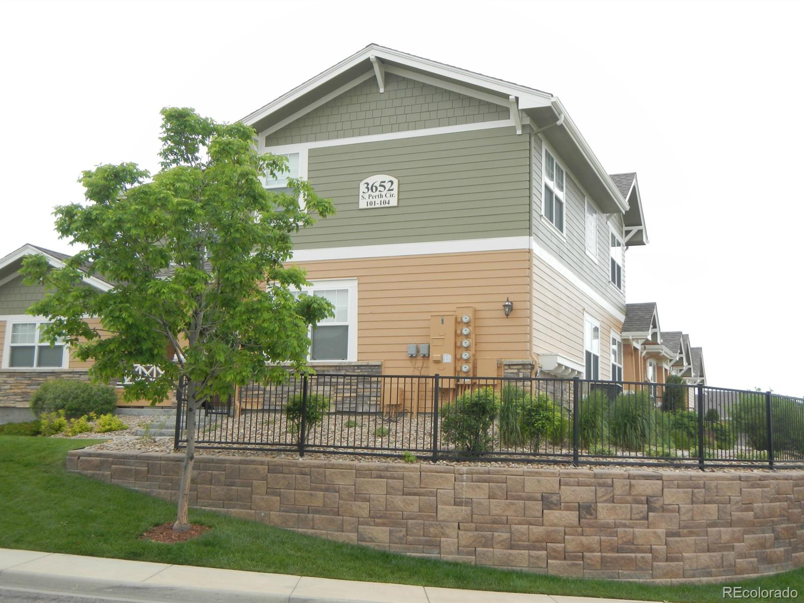 3652 South Perth Circle, Unit 102 Aurora, CO 80013 - Photo 5 of 17 a front view of a house with a yard
