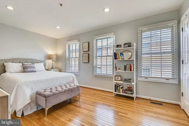 a spacious bedroom with a large bed and a window