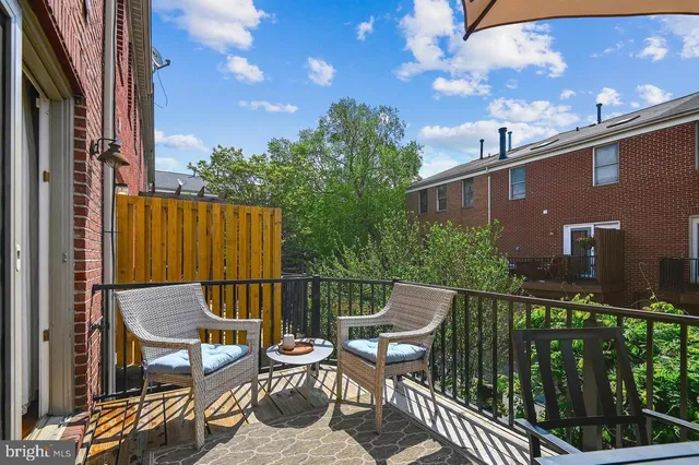 a view of a house with a door and wooden walls