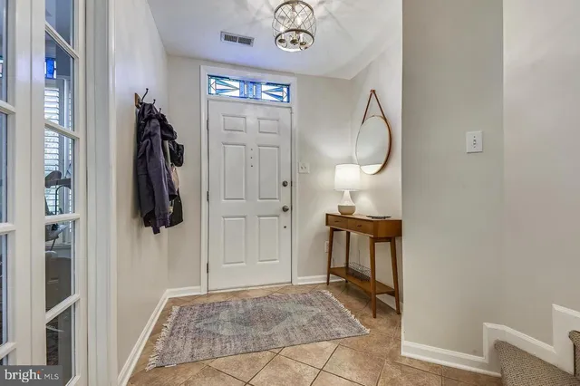 a living room with furniture a lamp and a rug