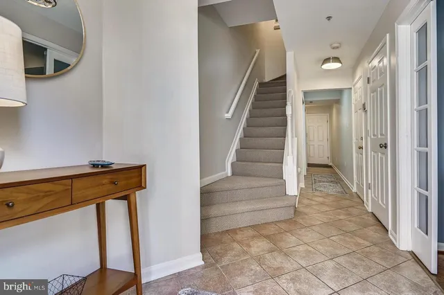 a living room with furniture a flat screen tv and a window