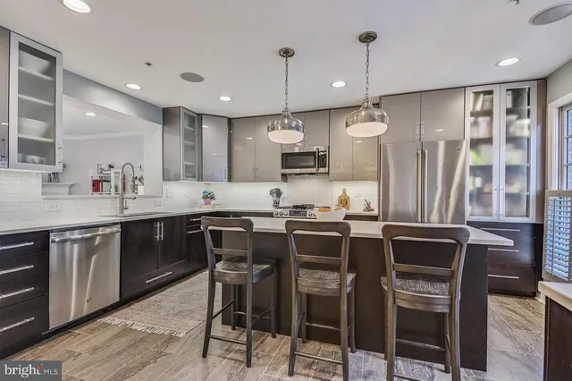 a kitchen with a stove and a fireplace with wooden floor