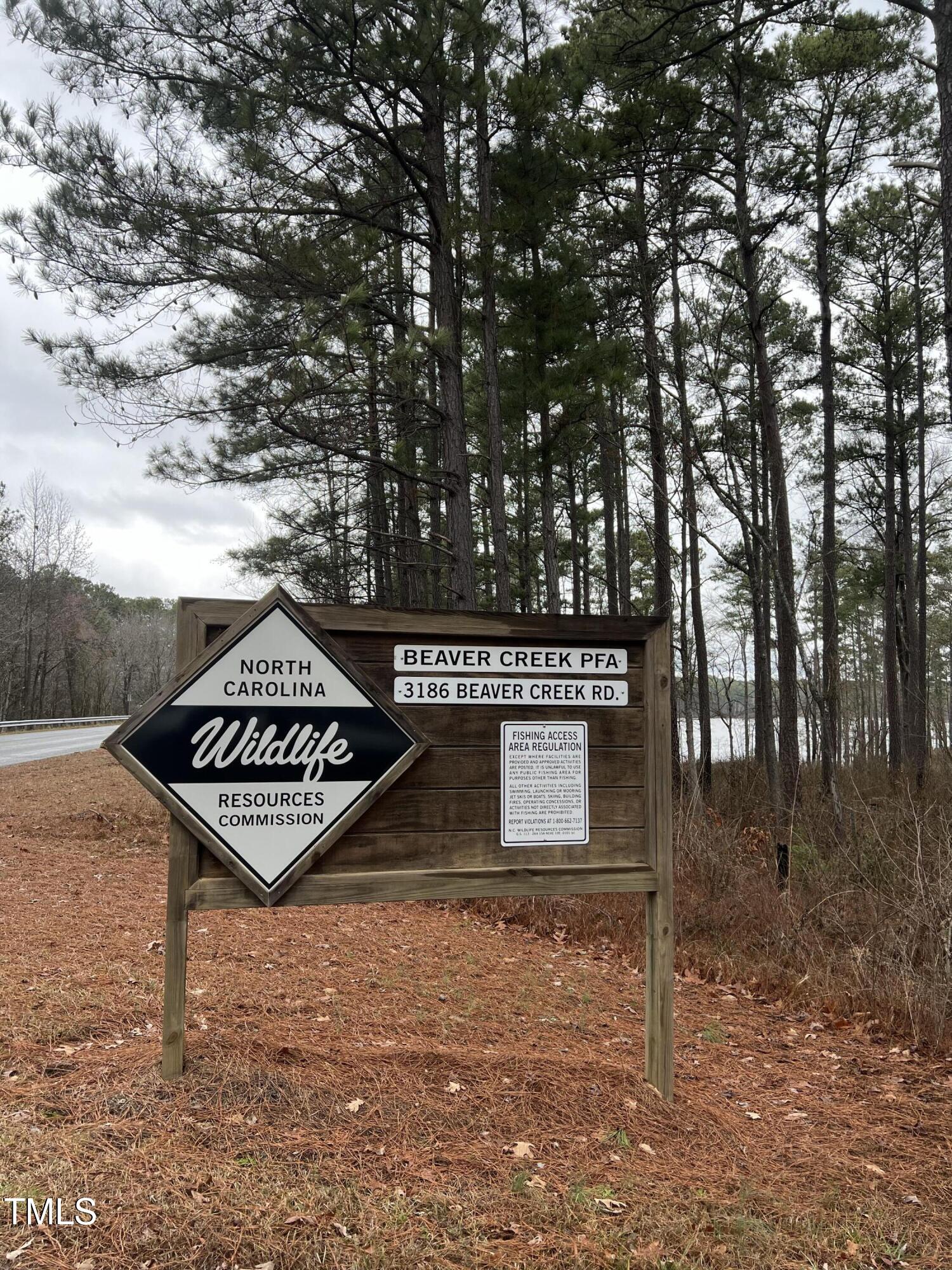 54 Anfield Road New Hill, NC 27562 - Photo 13 of 13 a view of a wooden sign under a tree