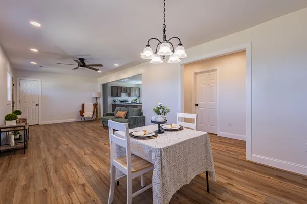 a view of a dining room with furniture wooden floor and chandelier