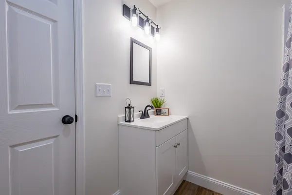 a bathroom with a sink vanity and mirror