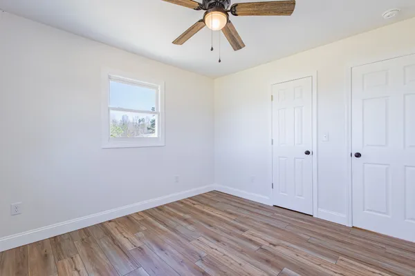 a view of a bathroom with wooden floor