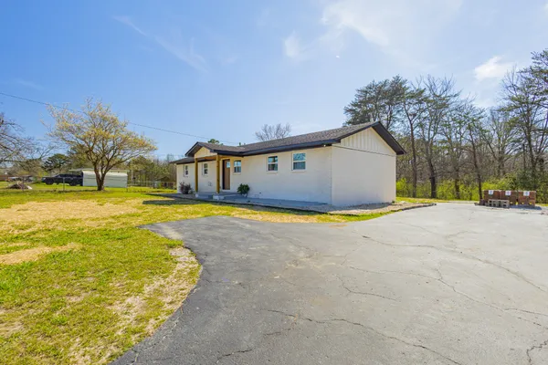 a front view of house with yard and swimming pool