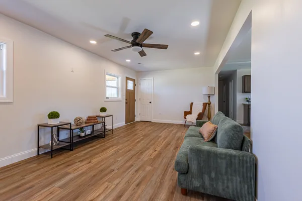 a bedroom with furniture and a wooden floor
