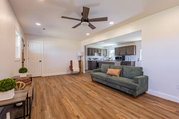 a living room with furniture and a wooden floor