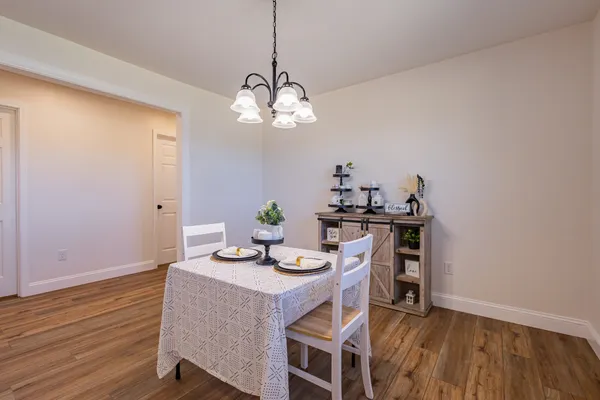 a view of a dining room with furniture wooden floor and chandelier